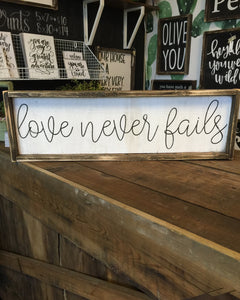Love Never Fails Cursive Wood Sign